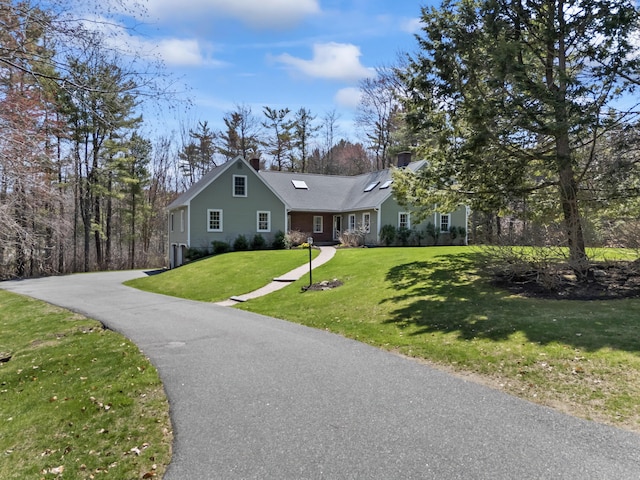 view of front of property with a chimney and a front lawn