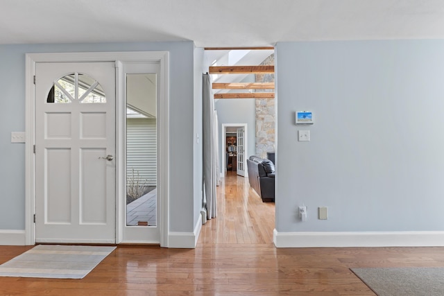 entrance foyer featuring wood finished floors and baseboards