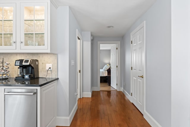 hall featuring hardwood / wood-style floors and baseboards