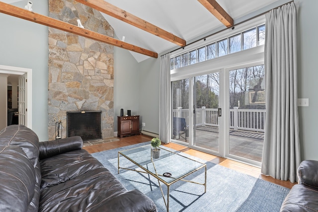 living area with beamed ceiling, wood finished floors, high vaulted ceiling, and baseboard heating