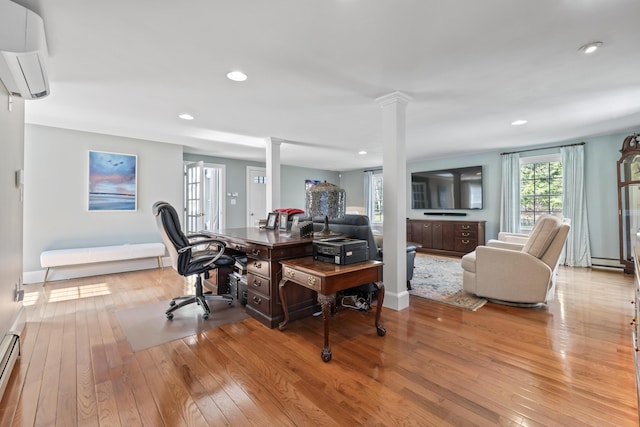 living room with recessed lighting, ornate columns, a wall unit AC, a baseboard heating unit, and light wood-style flooring