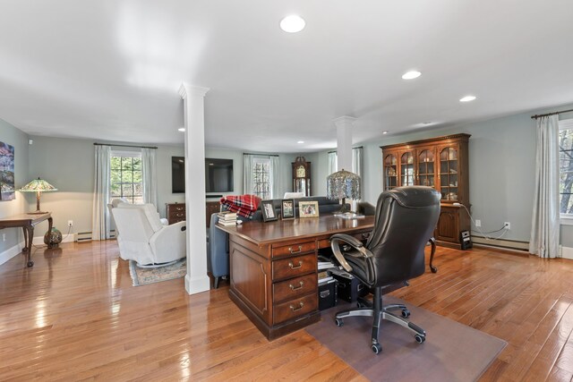 home office featuring light wood-style flooring, recessed lighting, and ornate columns