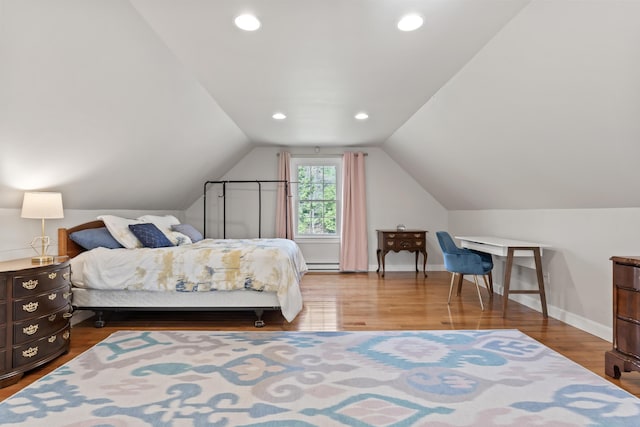 bedroom with a baseboard heating unit, baseboards, recessed lighting, lofted ceiling, and wood finished floors