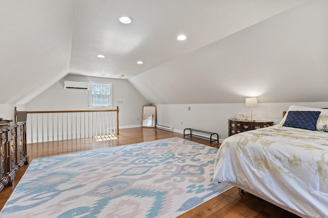 bedroom featuring an AC wall unit, vaulted ceiling, baseboards, baseboard heating, and wood finished floors
