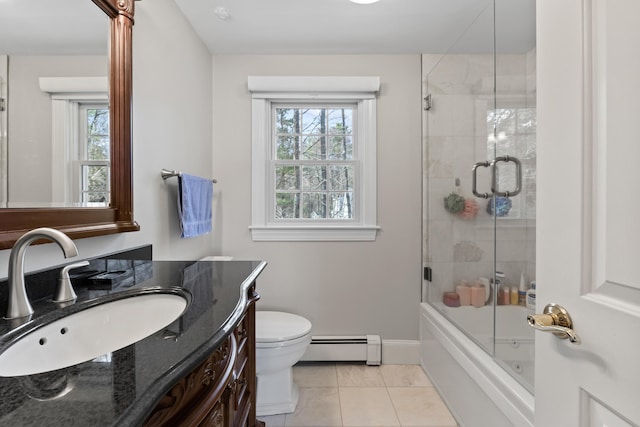 bathroom with a baseboard radiator, plenty of natural light, toilet, and tile patterned floors