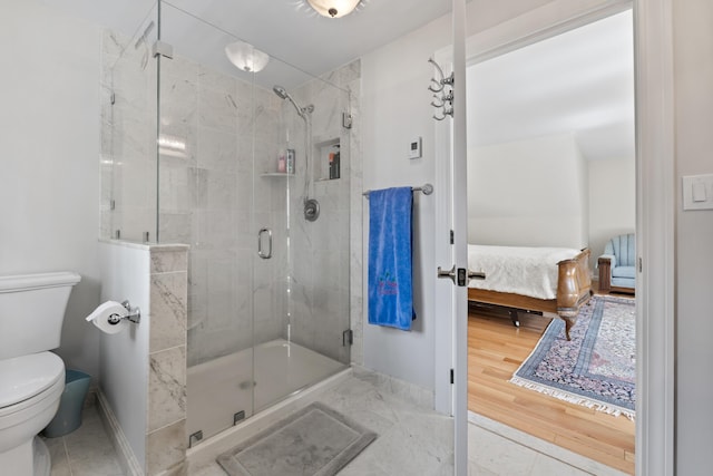 bathroom featuring baseboards, ensuite bath, toilet, and a stall shower