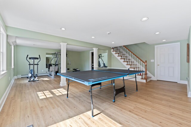 rec room featuring recessed lighting, light wood-type flooring, baseboards, decorative columns, and a baseboard radiator