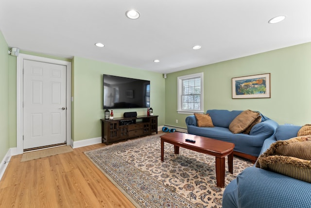 living room with recessed lighting, light wood-style floors, baseboards, and baseboard heating