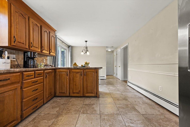 85 Tucker Ave, Portland, ME 04103 - kitchen featuring baseboard heating, a chandelier, brown cabinets, and a peninsula