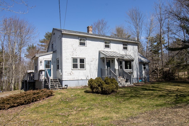 1114 Kennebec Rd, Hampden, ME 04444 - rear view of property featuring a yard, a chimney, a standing seam roof, and metal roof