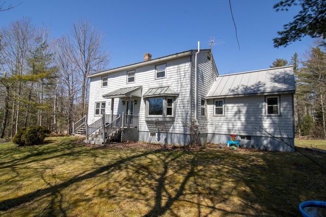 1114 Kennebec Rd, Hampden, ME 04444 - rear view of house with a yard, a chimney, a standing seam roof, and metal roof