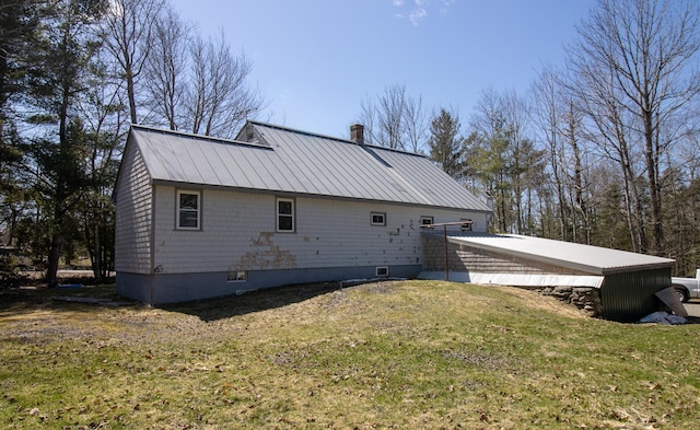 1114 Kennebec Rd, Hampden, ME 04444 - rear view of house with a chimney, a yard, and metal roof