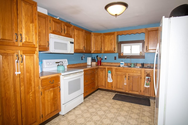 1114 Kennebec Rd, Hampden, ME 04444 - kitchen with light floors, brown cabinetry, white appliances, and a sink