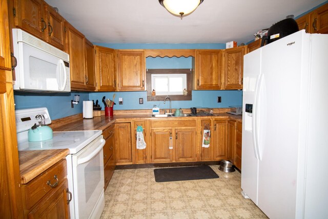 1114 Kennebec Rd, Hampden, ME 04444 - kitchen with light floors, brown cabinets, a sink, and white appliances