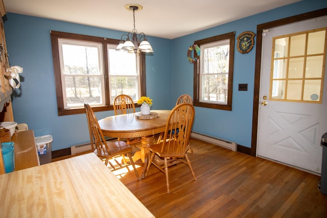 1114 Kennebec Rd, Hampden, ME 04444 - dining room featuring a baseboard heating unit, baseboards, wood finished floors, and a chandelier