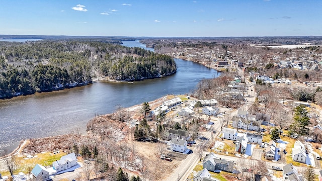 aerial view of property's location featuring a large body of water and a forest