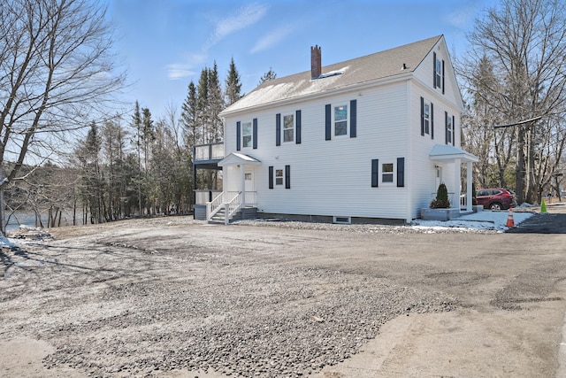 rear view of house featuring a chimney