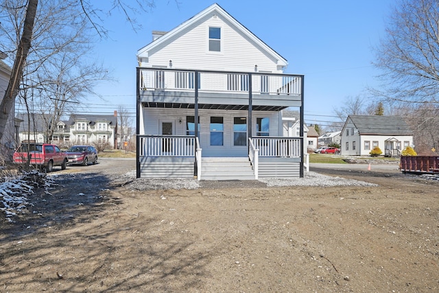 townhome / multi-family property featuring a balcony and covered porch
