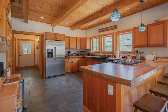 8 Sunset Ln, Kingfield, ME 04947 - kitchen featuring stainless steel appliances, a peninsula, beam ceiling, pendant lighting, and wooden ceiling