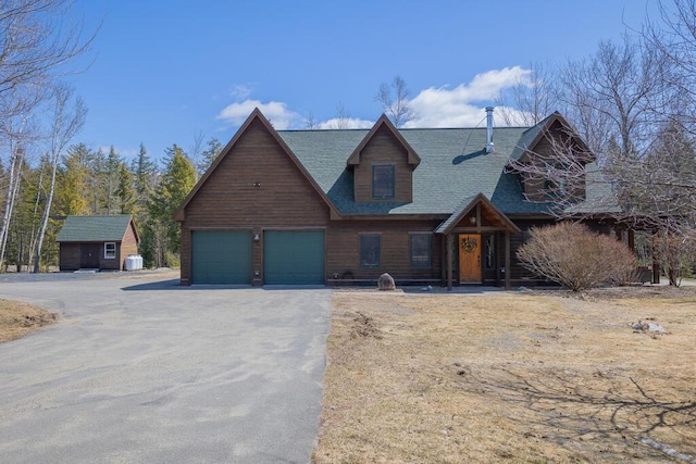 8 Sunset Ln, Kingfield, ME 04947 - view of front of property featuring a shingled roof, driveway, a storage unit, and a garage