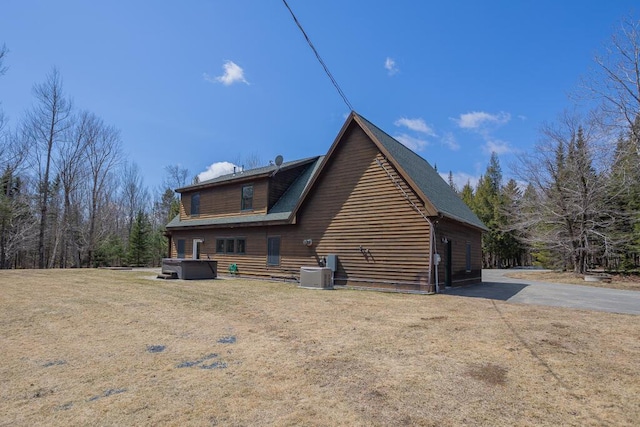 8 Sunset Ln, Kingfield, ME 04947 - view of property exterior with a lawn, central AC unit, and a hot tub