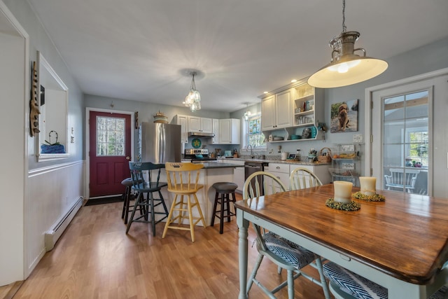 390 Castine Rd, Castine, ME 04421 - dining area featuring a baseboard heating unit and light wood finished floors