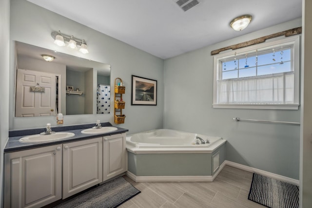 390 Castine Rd, Castine, ME 04421 - full bath featuring baseboards, a garden tub, and double vanity