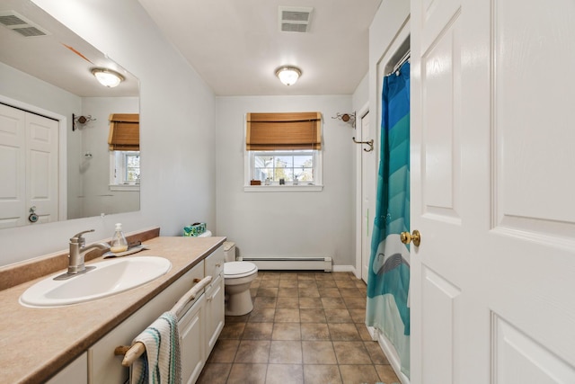 390 Castine Rd, Castine, ME 04421 - bathroom featuring toilet, plenty of natural light, vanity, and baseboard heating