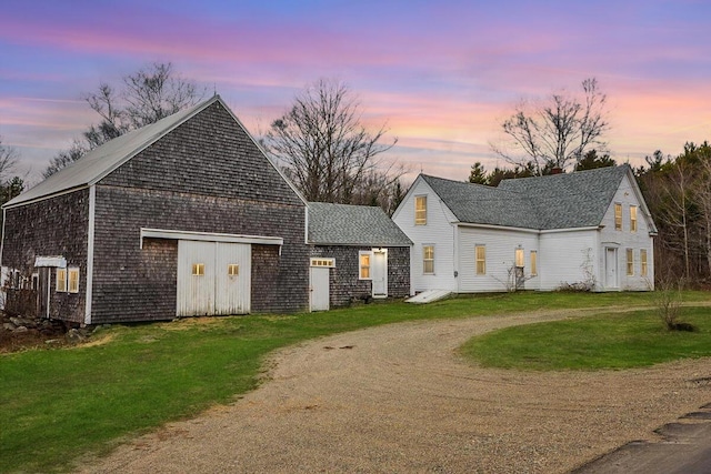 view of front facade with a front yard and dirt driveway