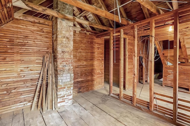 miscellaneous room with wood-type flooring and vaulted ceiling
