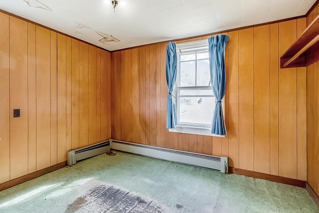 carpeted spare room with baseboards and wooden walls