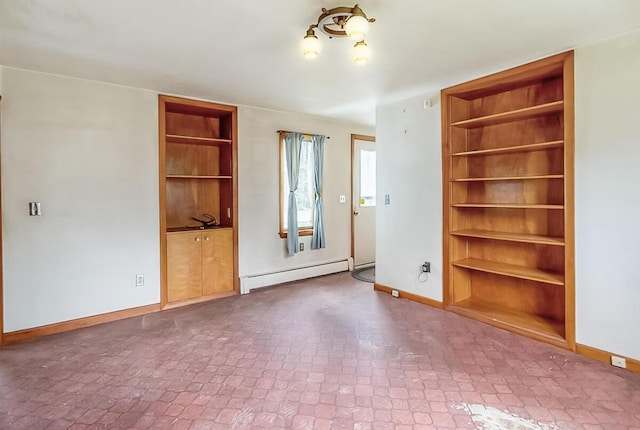 interior space featuring baseboard heating, built in features, and baseboards