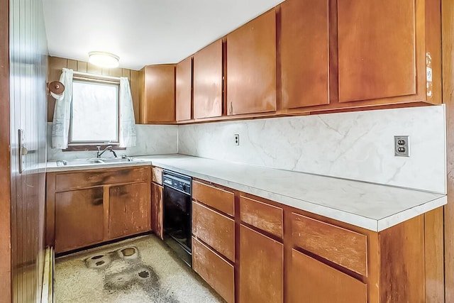 kitchen with a sink, dishwasher, backsplash, and light countertops