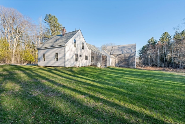 view of home's exterior with a lawn and a chimney