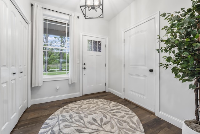 17 Wadlin Rd, Biddeford, ME 04005 - foyer entrance with a chandelier, baseboards, and dark wood-style floors