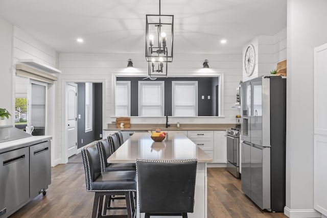 17 Wadlin Rd, Biddeford, ME 04005 - kitchen with appliances with stainless steel finishes, a sink, white cabinets, dark wood-style flooring, and light countertops