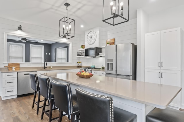 17 Wadlin Rd, Biddeford, ME 04005 - kitchen featuring appliances with stainless steel finishes, a sink, a chandelier, white cabinets, and recessed lighting