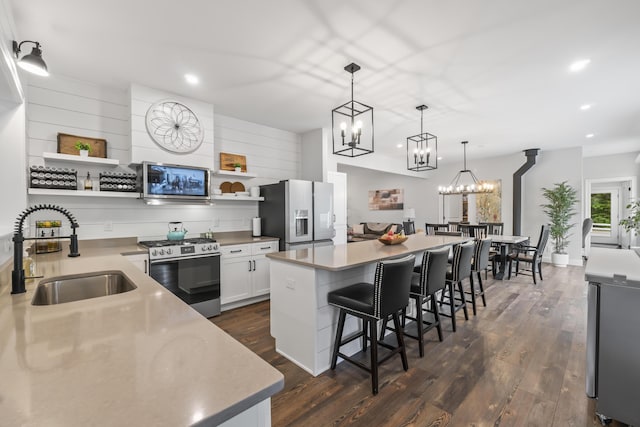 17 Wadlin Rd, Biddeford, ME 04005 - kitchen with appliances with stainless steel finishes, a sink, open shelves, dark wood-type flooring, and recessed lighting