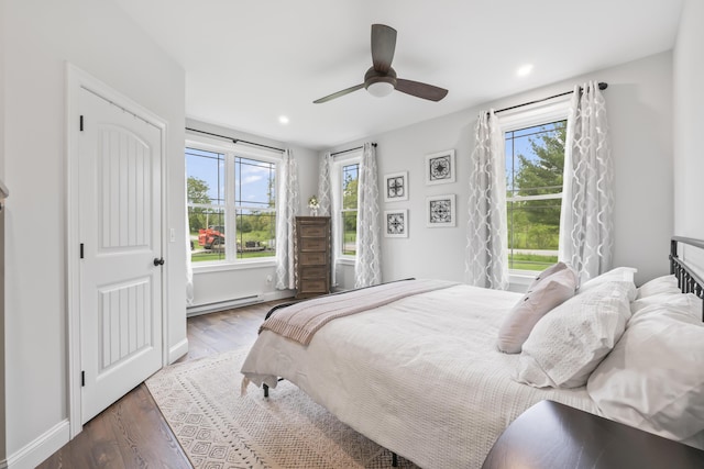 17 Wadlin Rd, Biddeford, ME 04005 - bedroom with a baseboard radiator, multiple windows, wood finished floors, recessed lighting, and a ceiling fan