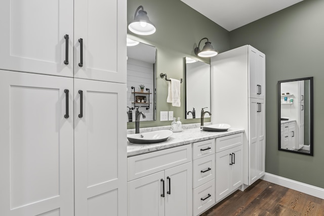 17 Wadlin Rd, Biddeford, ME 04005 - full bathroom featuring double vanity, wood finished floors, and baseboards