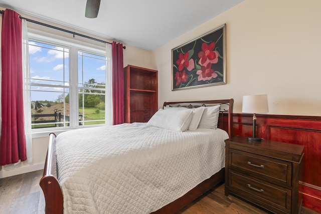 17 Wadlin Rd, Biddeford, ME 04005 - bedroom featuring dark wood-style flooring, a wainscoted wall, and ceiling fan