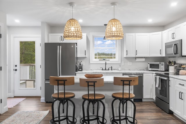 17 Wadlin Rd, Biddeford, ME 04005 - kitchen featuring appliances with stainless steel finishes, a sink, a breakfast bar area, recessed lighting, and white cabinetry