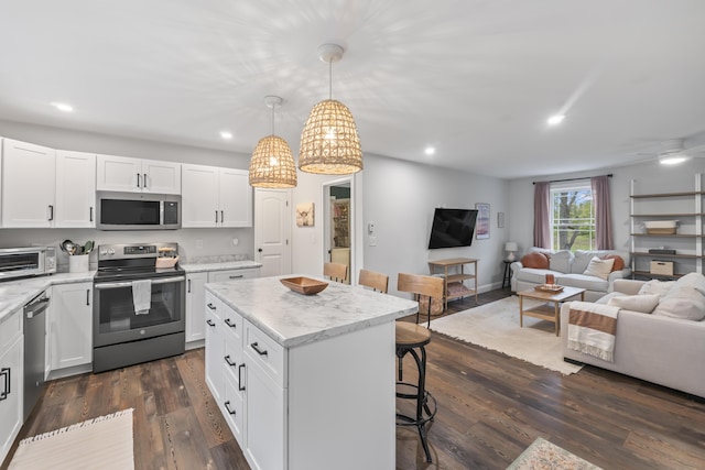 17 Wadlin Rd, Biddeford, ME 04005 - kitchen featuring stainless steel appliances, a kitchen breakfast bar, open floor plan, white cabinetry, and a kitchen island
