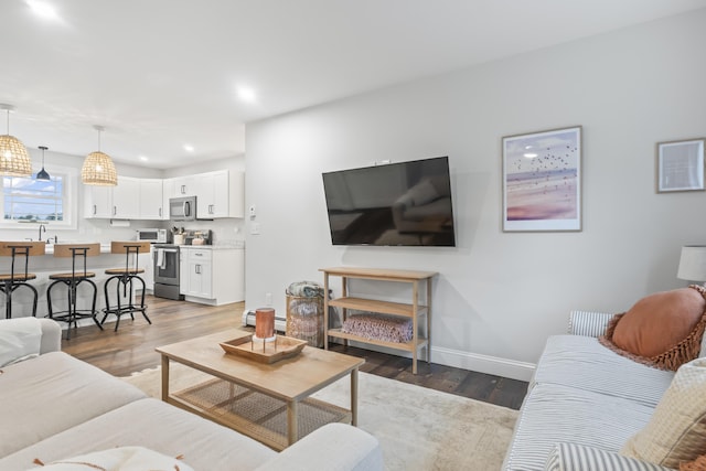17 Wadlin Rd, Biddeford, ME 04005 - living area featuring wood finished floors, baseboards, recessed lighting, and a baseboard heating unit