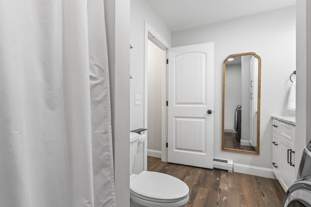 17 Wadlin Rd, Biddeford, ME 04005 - bathroom featuring baseboard heating, wood finished floors, toilet, vanity, and baseboards