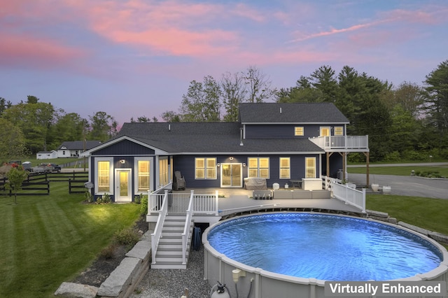 17 Wadlin Rd, Biddeford, ME 04005 - back of property at dusk with an outdoor pool, roof with shingles, a balcony, stairs, and a deck