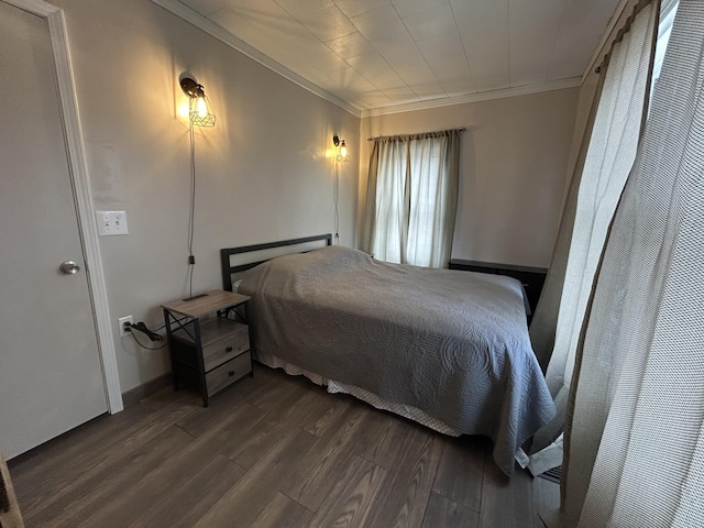 bedroom featuring crown molding and wood finished floors