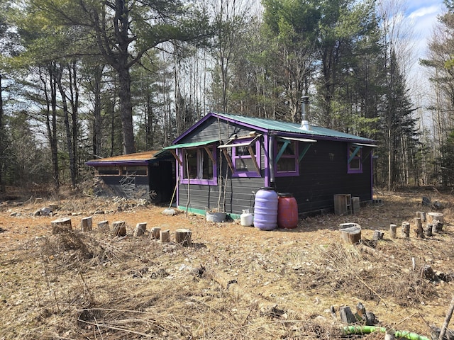 view of outbuilding with a forest view