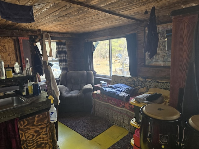 bedroom featuring concrete flooring, wooden ceiling, and multiple windows