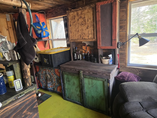 misc room with a wealth of natural light and wood walls